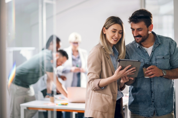 Two businesspeople looking at a tablet.